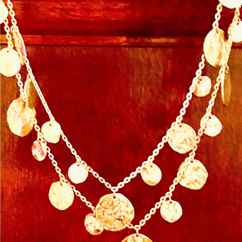 Gold tone double strand necklace. Hammered metal. Extends from 16” to 24 l“